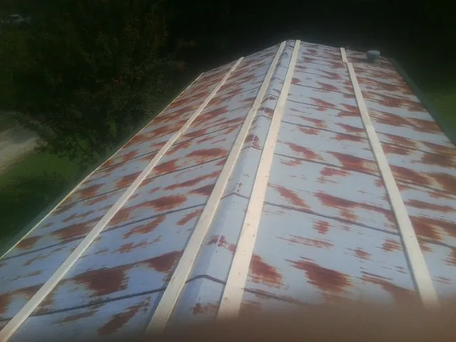 Rusted metal roof panels with new wood purlins before replacement — Storm Damage Roof Repair in Presto by Roofing Brothers