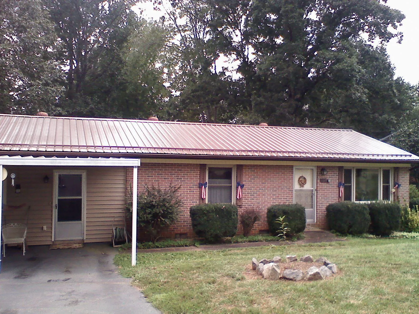 Bronze metal roof and carport on a brick ranch home — Roof Repair work by our crew in Presto